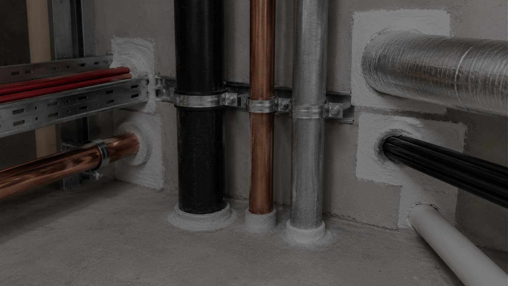 Fire-stopped service penetrations sealed around pipes, ducts and cables to help maintain compartmentation and passive fire protection within commercial buildings.